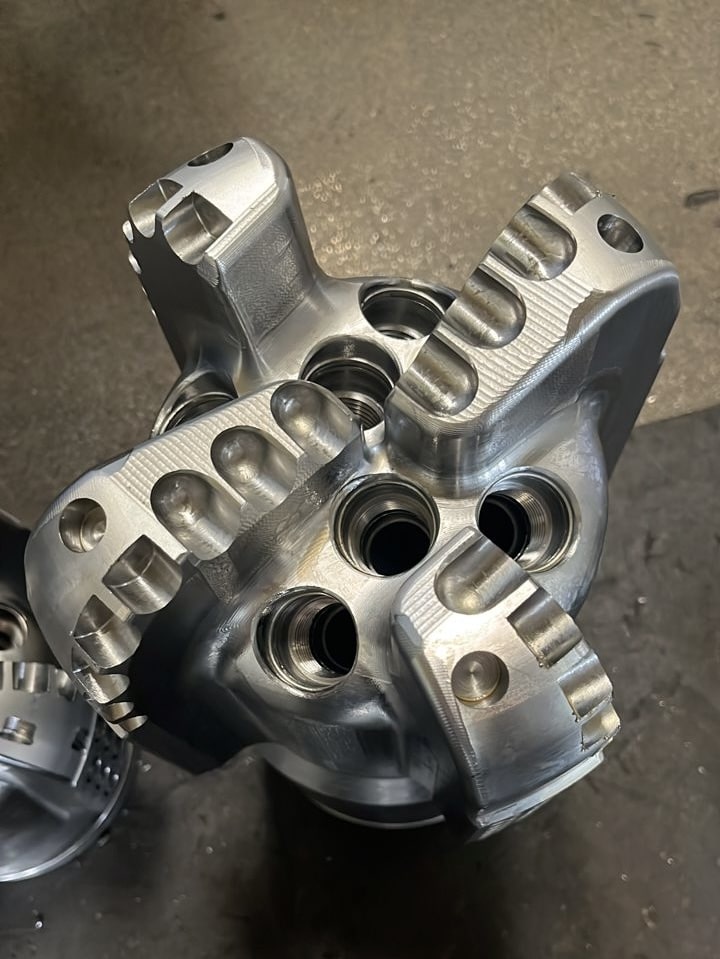 Metallic drill bit with intricate design.